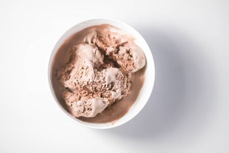 Melting chocolate ice cream in a white ceramic cup.の写真素材