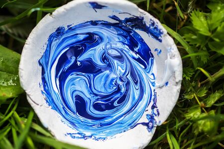 Oil paints mixed in handmade clay cup prepared for painting.の写真素材