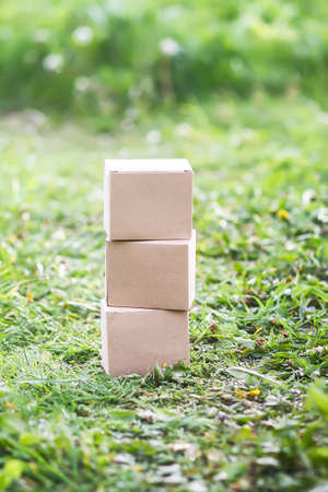 Cardboard boxes on green grass outdoors.の写真素材