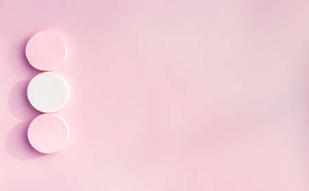 Cosmetic sponges in pastel colors on pink background.