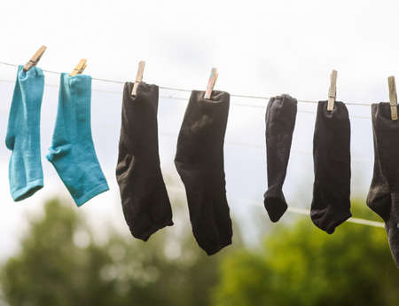 Colorful laundry hanging on the rope outdoors. The process of air drying clothesの写真素材
