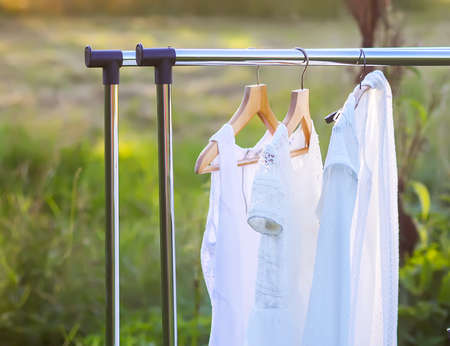 Linen dresses hanging on a hanger outdoors in summer dayの写真素材