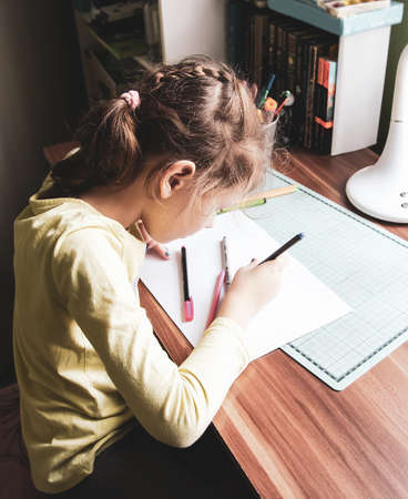 A girl doing her homework at home.