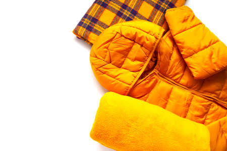 Warm yellow jacket and woolen soft plaids on white background. Fashion outfit. Bright colors. Home storage. Small space organizingの写真素材