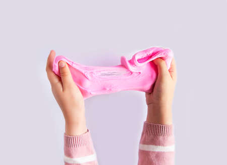 Pink slime mass in child's hands.の写真素材