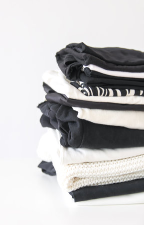Stack of folded colorful clothes. Compact storage organizing in home wardrobe.