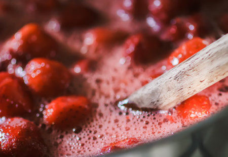 Strawberry jam oreparing process. Berries are boiled in a saucepan