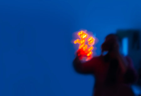 Human unrecognizable silhouette with shiny lights in a dark room.の写真素材