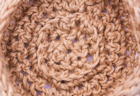 Handmade washcloth made of jute lies.の写真素材