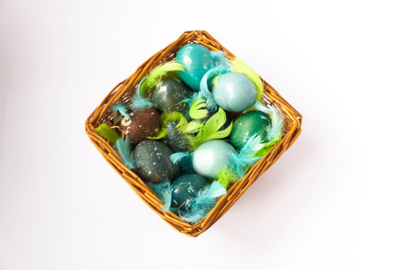 Colorful Easter eggs in a basket. Traditional festive decor.