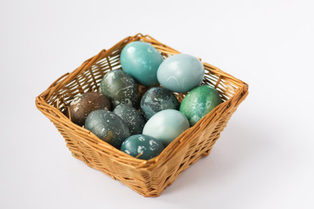 Colorful Easter eggs in a basket. Traditional festive decor.