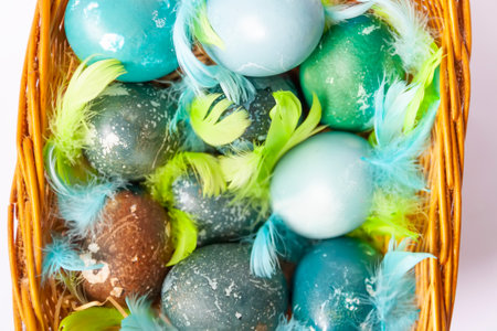 Colorful Easter eggs in a basket. Traditional festive decor.