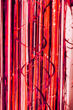 Birthday party decor. Foil curtains and bauble. Cozy home interior decoration for celebration.の写真素材