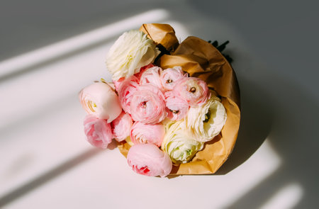 Bouquet of Ranunculus beautiful delicate flowers. Floral decor. Bright sunlight and shadows on a...