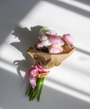 Bouquet of Ranunculus beautiful delicate flowers. Floral decor. Bright sunlight and shadows on a...