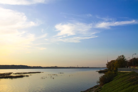 Peaceful landscape with lake in autumn sunset light in Latvia.の写真素材