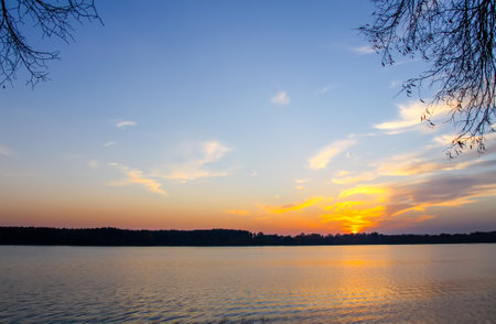 Peaceful landscape with lake in autumn sunset light in Latvia.の写真素材