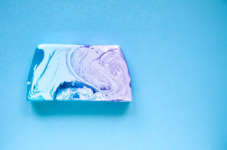 Natural handmade organic soap bar on colorful background.
