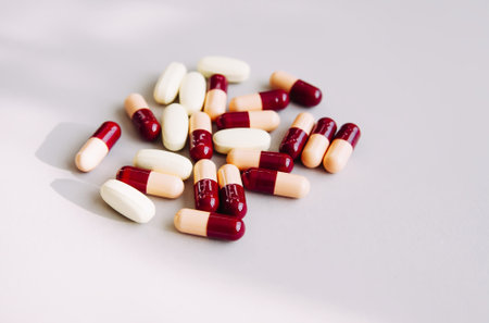 Pills scattered on light background. Medicine theme.の写真素材