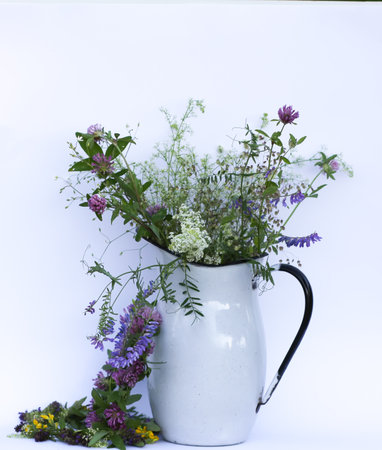 Beautiful bouquet of mixed summer flowers in a vintage jug.の写真素材