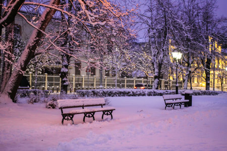Romantic evening view of snowy park with lanterns in Riga.の写真素材