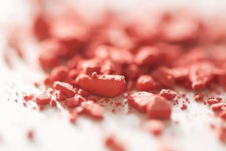 Scattered blush pigments on a neutral surface. A minimal beauty background with soft texture.の写真素材