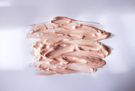 Liquid product sample smear with delicate flow pattern. A tactile image of modern skincare design.