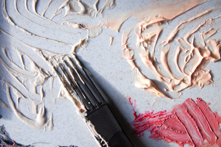 Smeared liquid cosmetic texture with glossy finish on neutral background. A modern visual of...