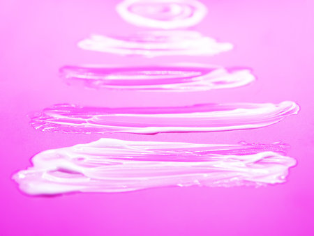 Soft white cream creating artistic organic shapes. Minimalistic beauty composition.の写真素材