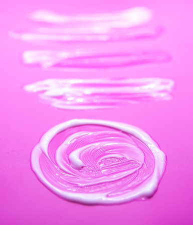 Soft white cream creating artistic organic shapes. Minimalistic beauty composition.の写真素材