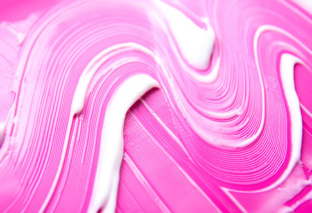 White skincare product on vibrant pink backdrop. Contrast of purity and bold color tones.