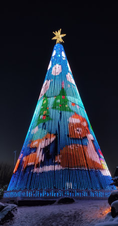 Riga, Latvia -14. 12. 2022 - Christmas tree shining near the Lido restaurant building at night.の写真素材