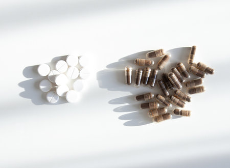 Capsules and tablets on neutral surface. Symbol of balance, immunity, and wellness culture.の写真素材