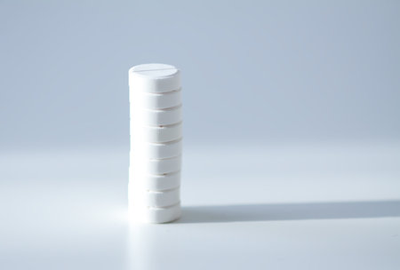 Various pills stacked on white background. Expresses clarity, vitality, and self-care.
