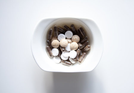 Pills and capsules of various natural colors. Represents health, wellness, and daily supplements.の写真素材