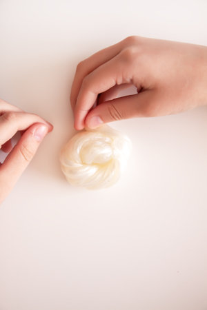 Close-up of little hands playing with bright slime. Symbolizes imagination and tactile learning.の写真素材