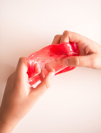 Child touching soft elastic slime. A playful moment of creativity and discoveryの写真素材