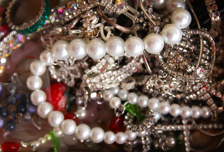 A piece of jewelry rests inside an opened box with soft light. The scene conveys elegance, care, and a sense of special occasion.の写真素材