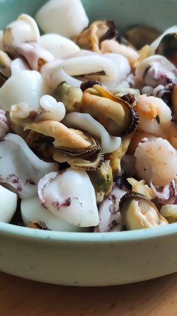 A bowl of clams and mussels ready for cooking. The view conveys wholesome nutrition, marine flavors, and culinary simplicity.の写真素材