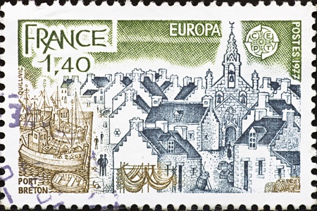 FRANCE - CIRCA 1977: A stamp printed in France,shows panoramic of Port Breton,circa 1977.のeditorial素材