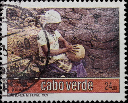 CABO VERDE-CIRCA 1990: A post stamp printed in Cabo Verde,shows villager doing traditional work, circa 1990.のeditorial素材