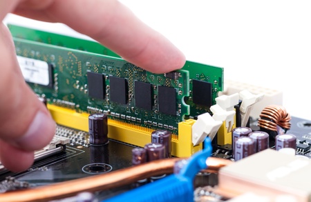 Hand Installing RAM Memory Module on PC Motherboard の写真素材