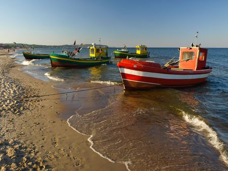 Old fishing boats at the beach in Sopot, Poland.の写真素材