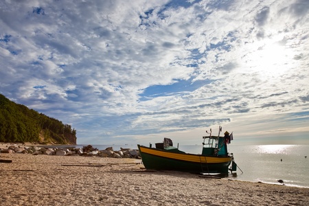 Old fishing boat at the beach in Orlowo, Poland.の写真素材