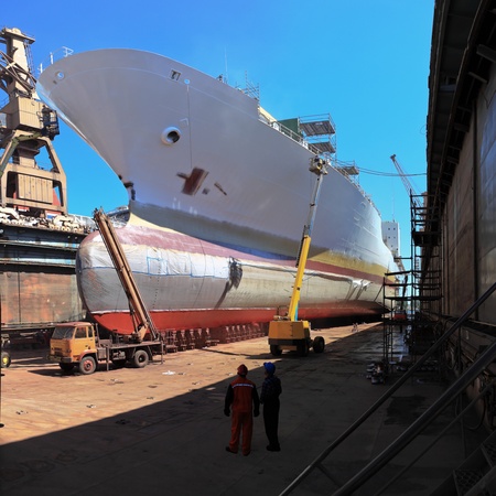 A large cargo ship is being renovated in shipyard Gdansk, Poland.のeditorial素材