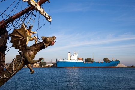 Ship in port on the background of the sculpture of the dragon knight. Gdynia, Poland.のeditorial素材