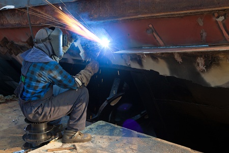 Welder in a protective mask when working. Photo taken on: August 26th, 2011