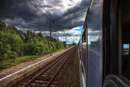 Dark rain clouds accompanying the train の写真素材