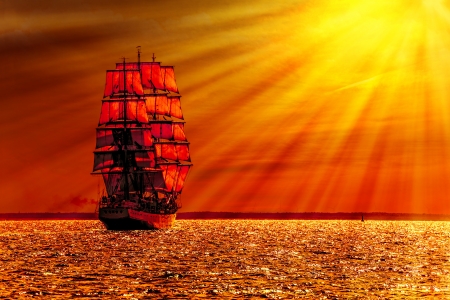 Sailing ship on the sea at sunset skyline の写真素材