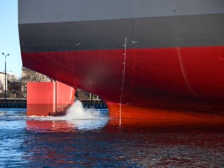 A ships stern on a working harbour 